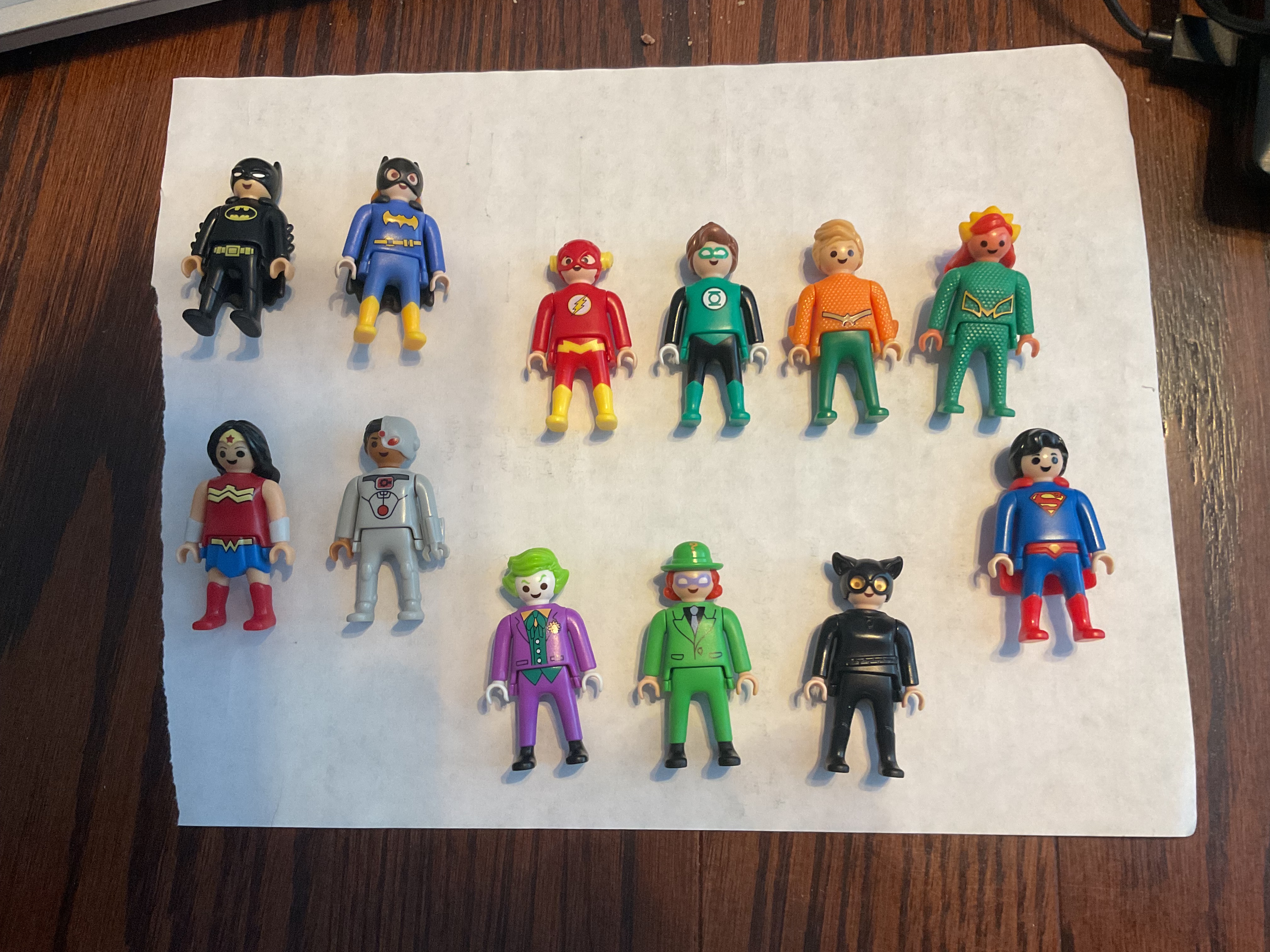 Twelve DC Comics Playmobil figures: Batman, Batgirl, Flash, Green Lantern, Aquaman, Mera, Wonder Woman, Cyborg, Joker, Riddler, Catwoman, Superman